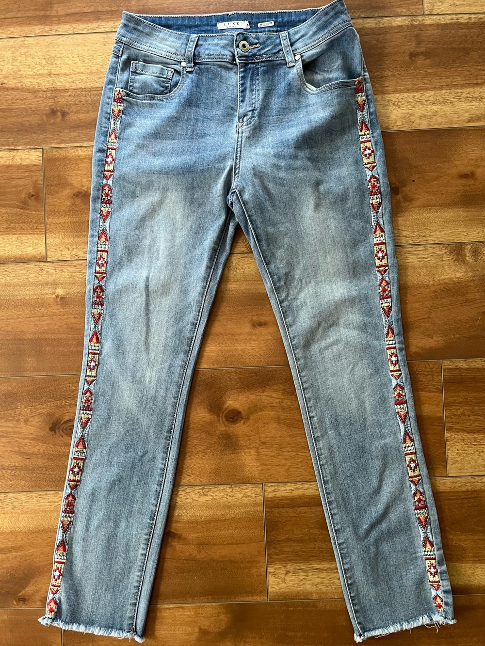Luxe Moda Light Blue Skinny Jeans with Aztec Red Embroidered Side Trim